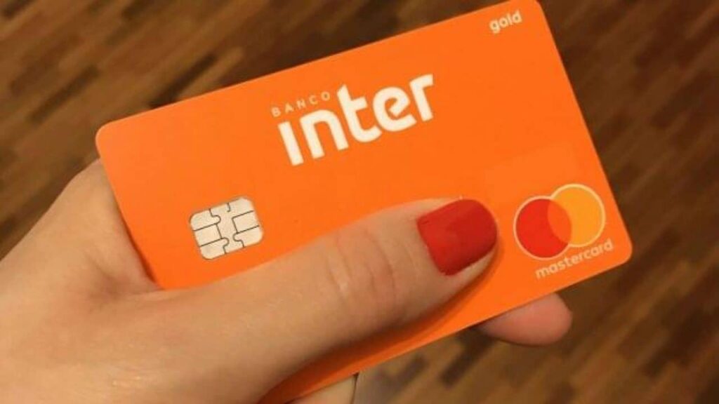 imagem de pessoa segurando cartão inter e avaliando cashback